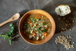 wood soup bowl with soup and bread