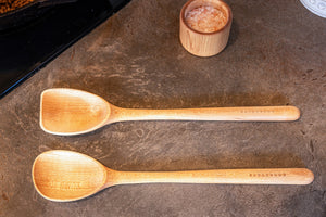 cooking and scraper spoon on counter next to salt cup