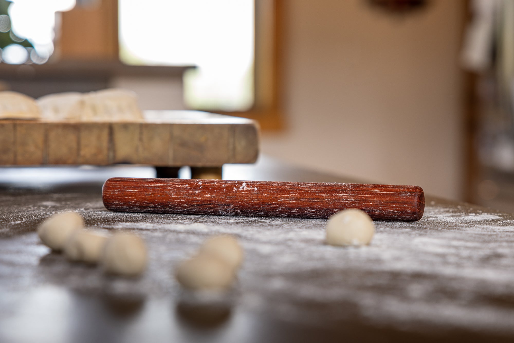 dumping pin on floured surface with dough balls