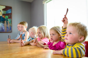 kids holding personalized wood baby spoons from Earlywood