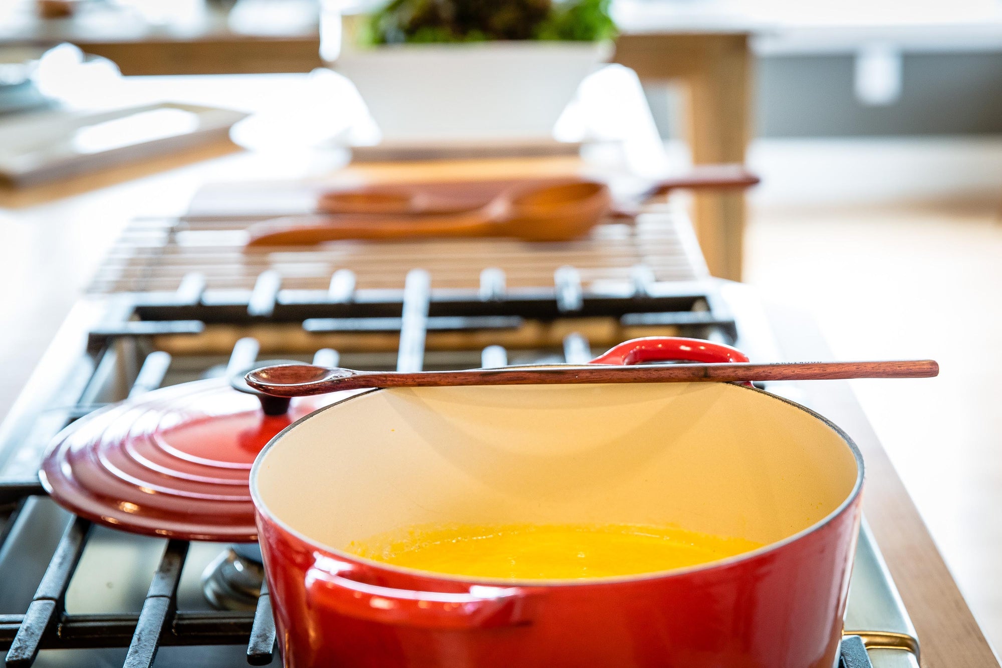 using chef tasting spoon in brown wood to taste soup - Earlywood