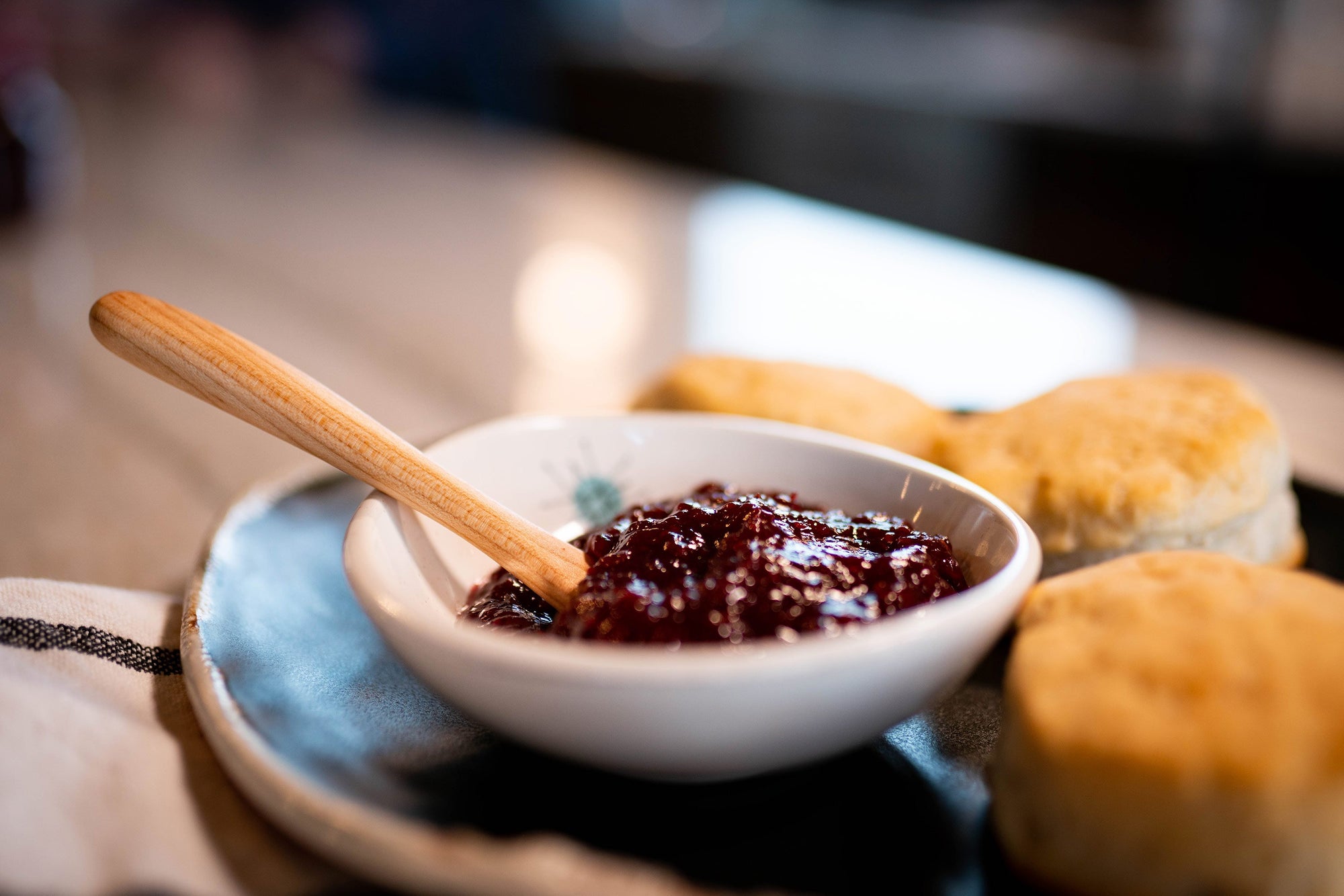 tiny wood spoon in bowl of jelly - Earlywood