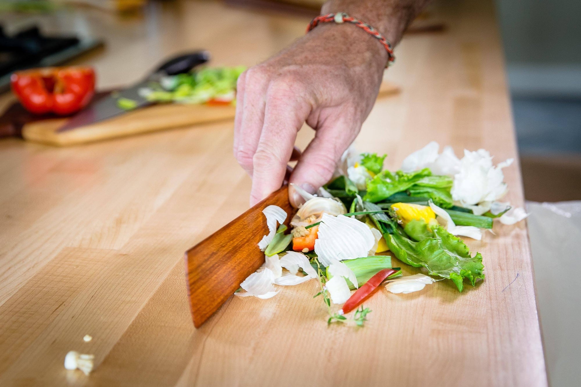 cleaning countertop with wood spatula that works as bench scraper - Earlywood