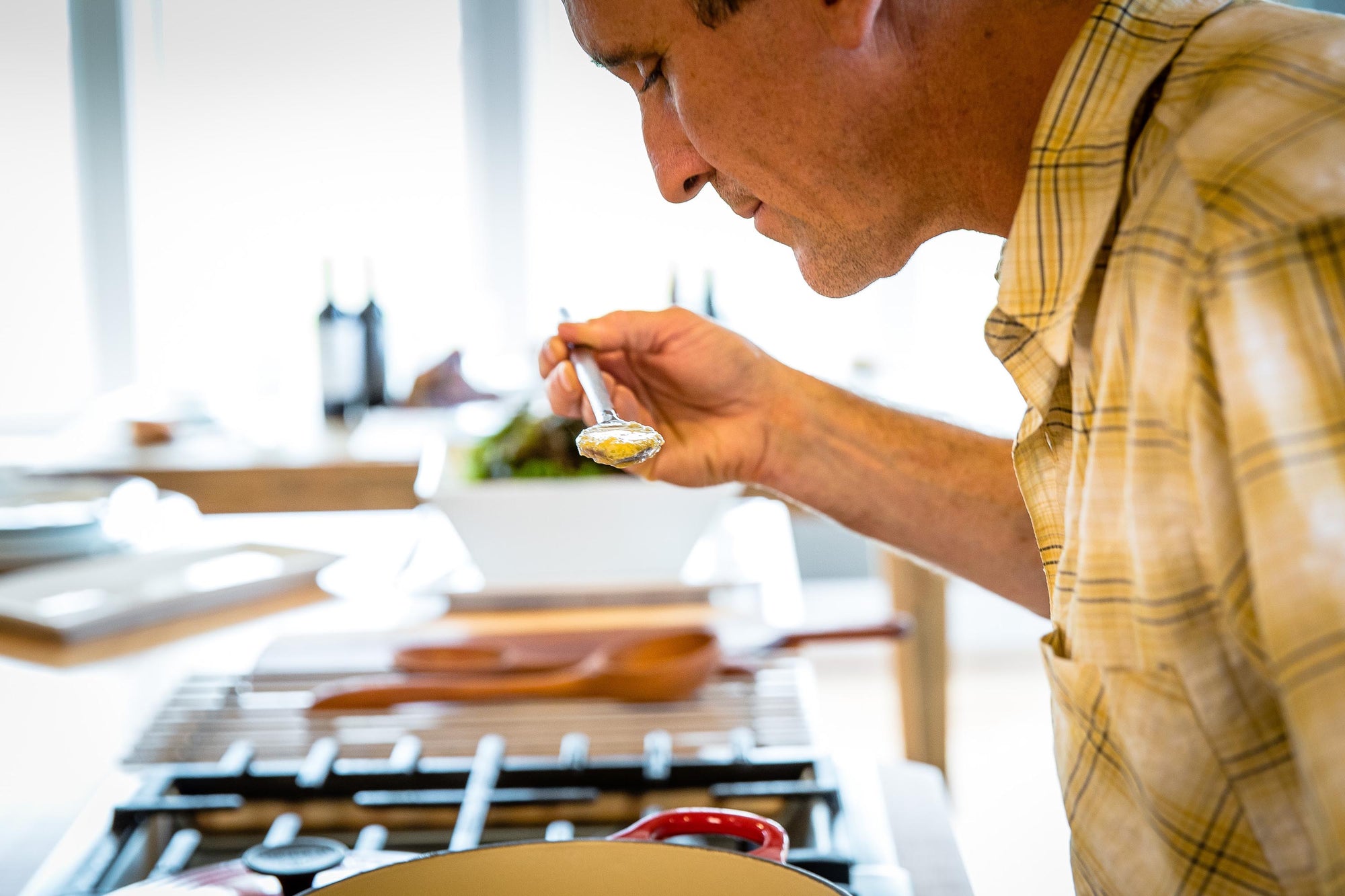 Chef tasting spoon in use with big batch of soup - Earlywood