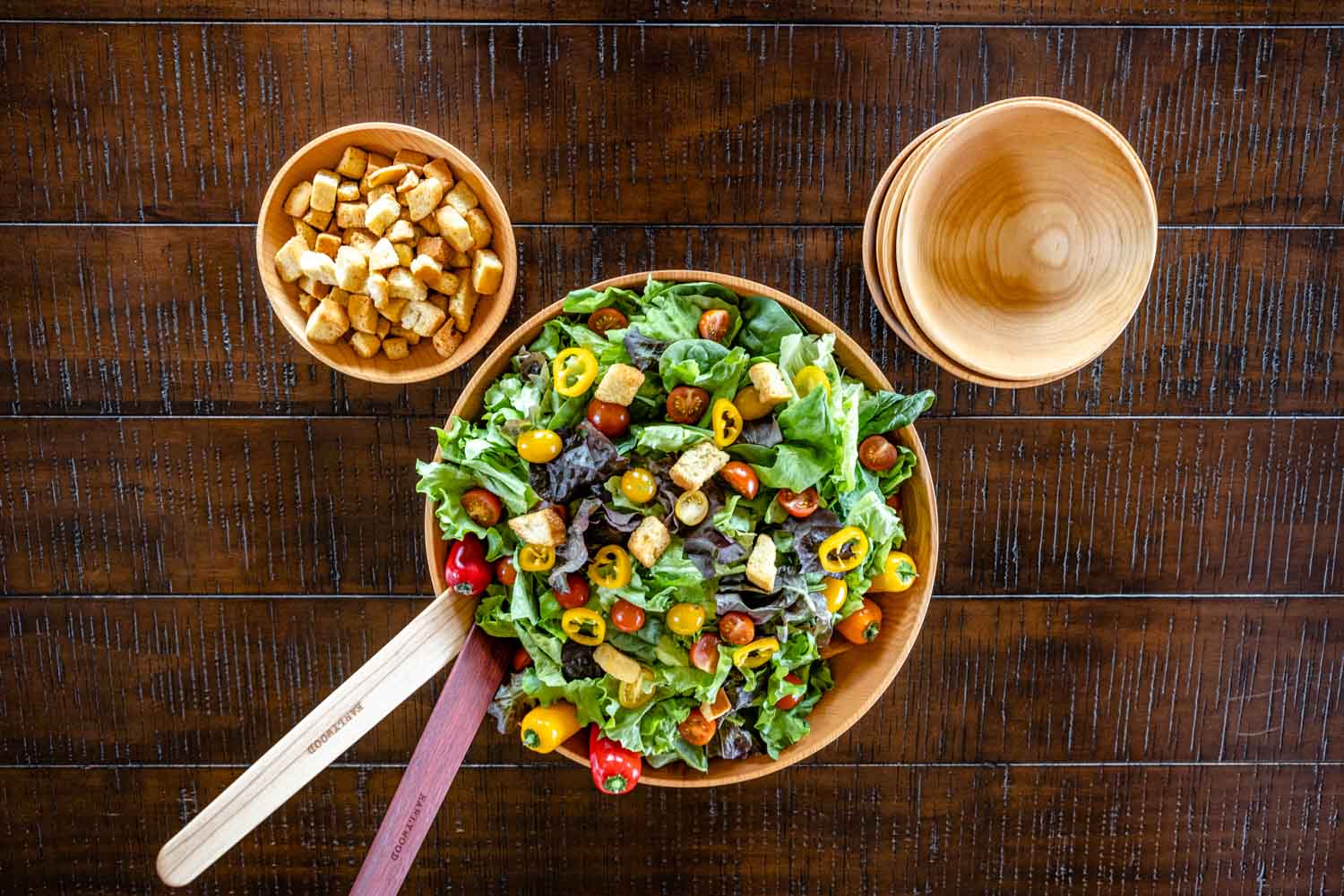 wooden bowls with salad on table